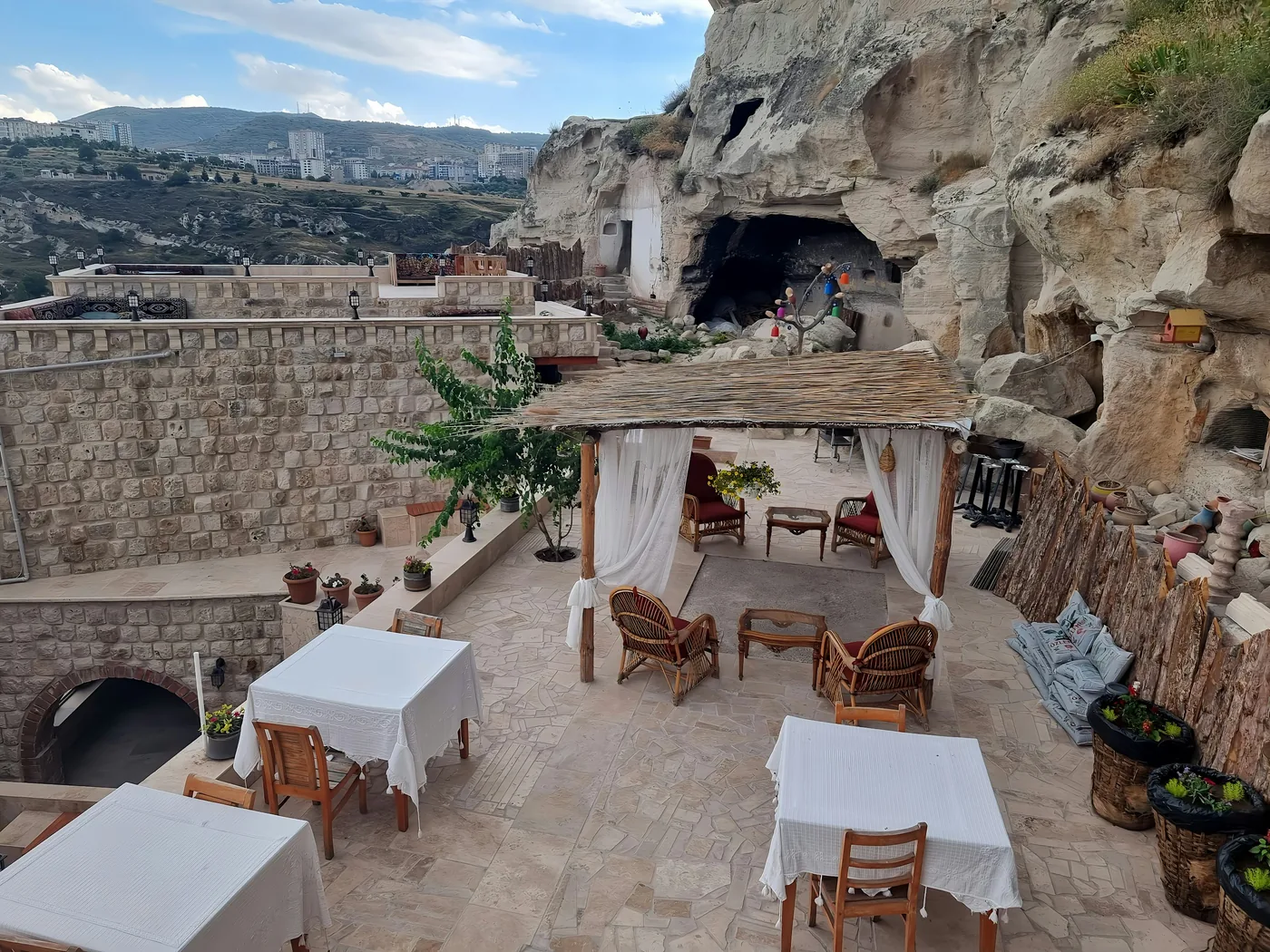 The stone interior of a candlelit cave restaurant set for a Turkish Night