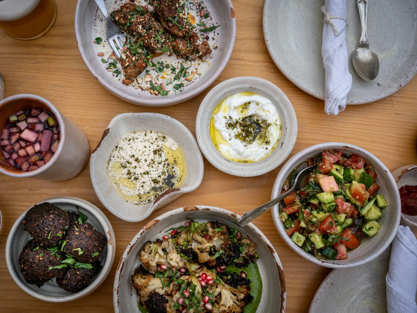 A set Turkish dinner laid out on long stone tables inside a cave venue