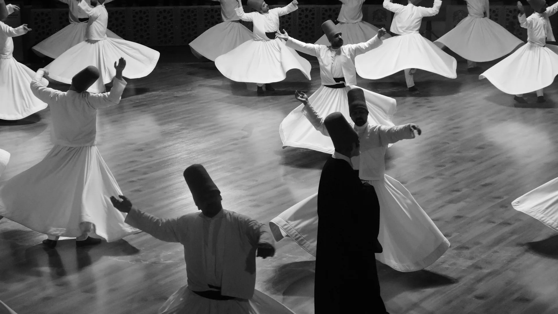 Dancers performing in traditional dress inside a candlelit cave restaurant in Cappadocia